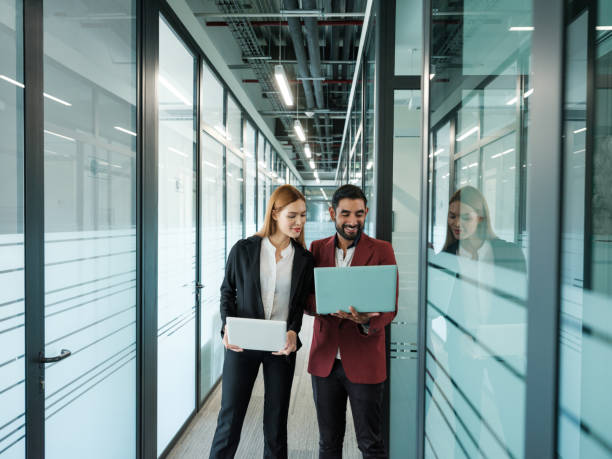istock Business colleagues looking at information with laptops together 1155328014