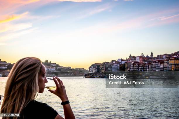 A Woman Admires The Sunset Over The Douro River Illuminating Porto Stock Photo - Download Image Now