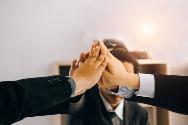 istock Businesspeople teamwork group putting their hands together agreement plan in meeting room, investment concept, success concept