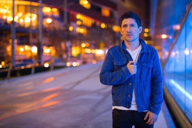 istock Hispanic man exploring the city streets at night 1155331060
