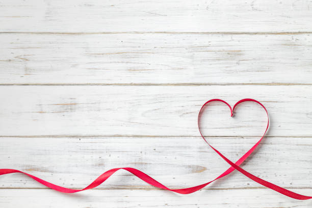 istock White board background and heart ribbon 1155336475