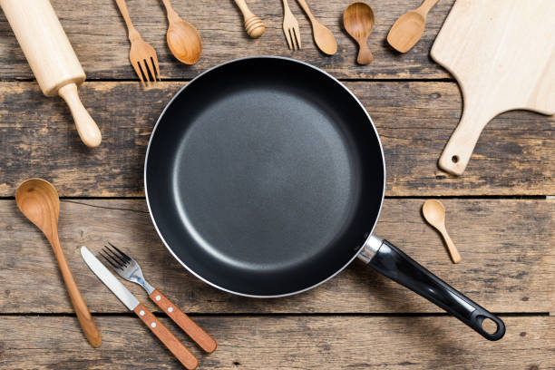 istock Cooking background,Top View of a Pan and different kitchenware On Old Wood Background 1155339880