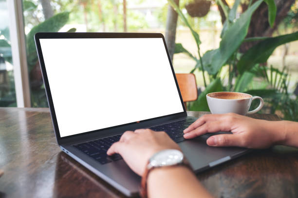 istock a woman using and typing on laptop with blank white desktop screen 1155341496