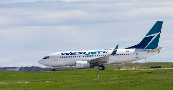 A Westjet Boeing 737-700 with identification C-GWBT taking off from Calgary International Airport. YYC
