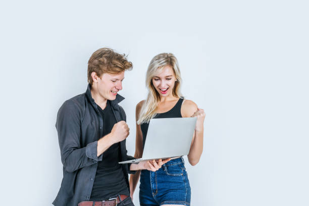 istock Portrait of happy young couple using laptop computer in studio 1155341705
