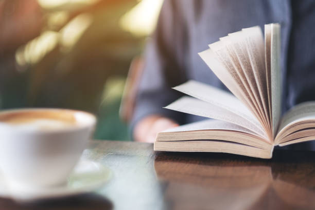 istock a woman holding and reading a book 1155341717