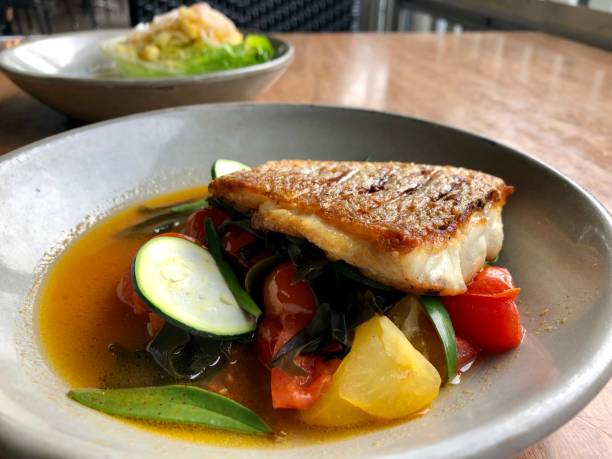 istock Snapper Fillet with Vegetables in a Grey Ceramic Plate 1155342307