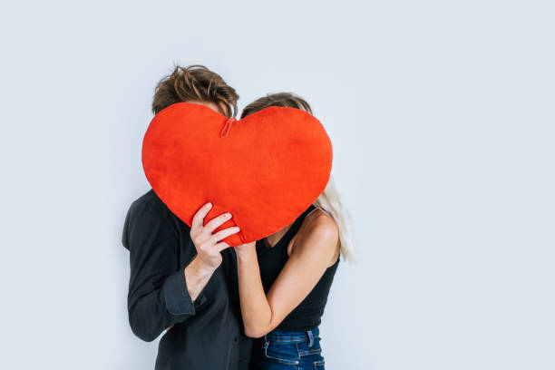 istock Happy couple loving together holding a red heart 1155346152