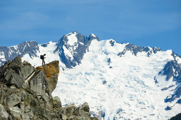 istock Mid distance view of hiker standing on mountain 1155348725