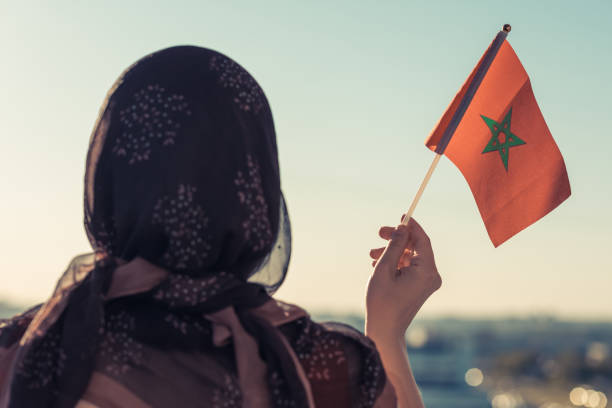 Muslim woman in scarf with Morocco flag of at sunset.Concept Muslim woman in scarf with Morocco flag of at sunset.Concept moroccan woman stock pictures, royalty-free photos & images