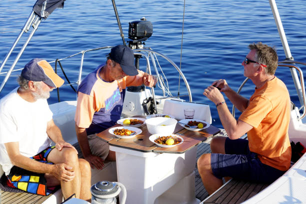 Three men having Chili Con Carne on sailing boat