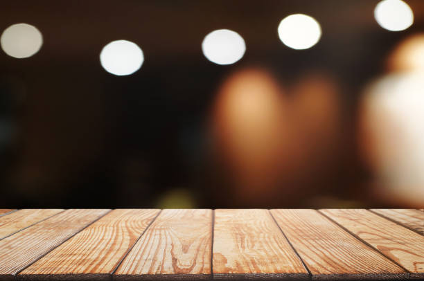 istock empty wood table top over blur in restaurant cafe background. 1155357021