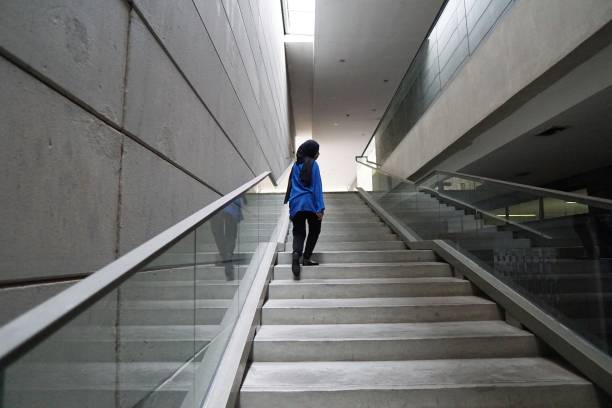 istock A woman walking at the stairs 1155357357