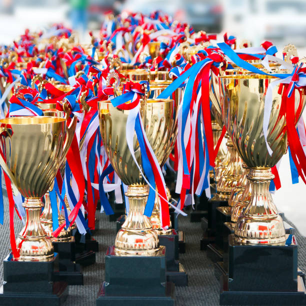 istock Rows of Golden Trophy Cups with Red, White and Blue Stripes Attached. 1155358429