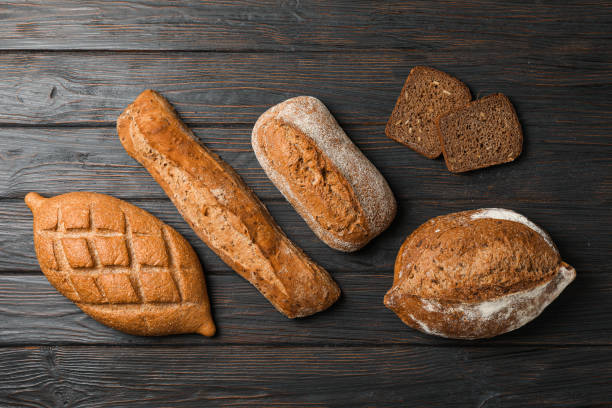istock Flat lay composition with bakery products on wooden background, top view and space for text 1155358543