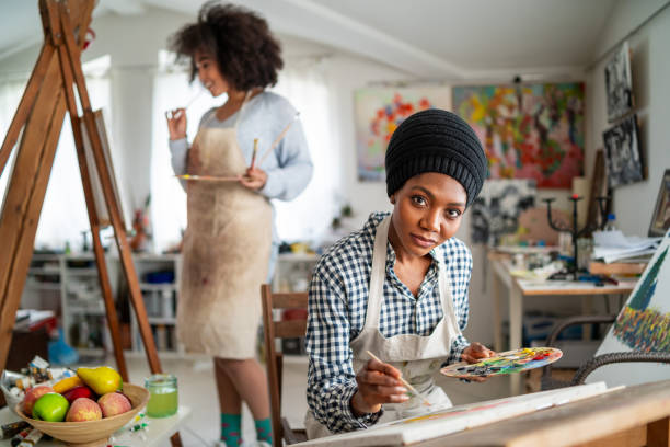 istock Afro Female fine artists drawing in studio 1155361135