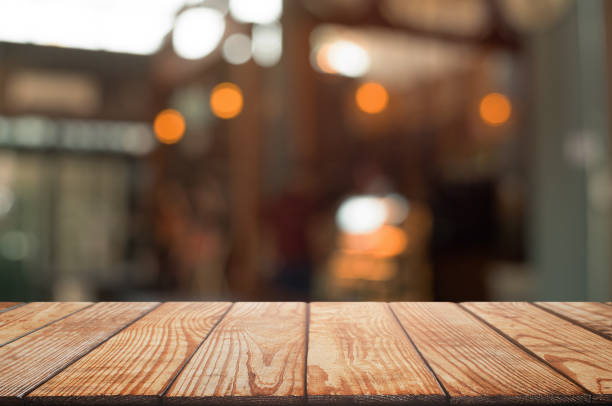 istock empty wood table with blur montage restaurant background 1155361219