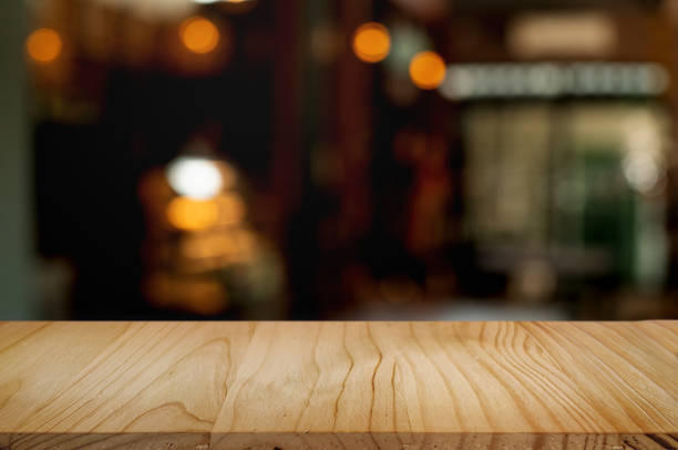 istock empty wood table with blur montage coffee shop or restaurant background. 1155361800