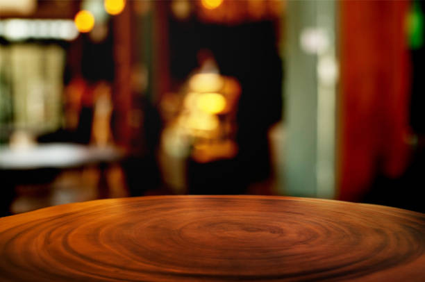 istock empty wood table with blur montage coffee shop or restaurant background. 1155361850