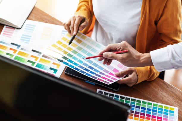 istock Interior or Graphic designer meeting discussing about color chart in studio. 1155361858