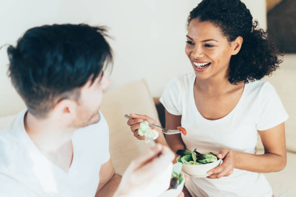 istock Couple in love eating salad 1155362010