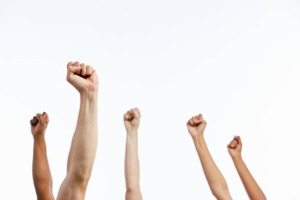 istock Five mixed, raised hands with fists clenched in solidarity 1155362420
