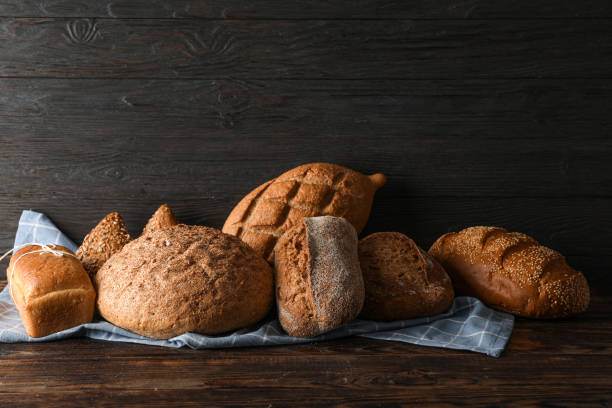 istock Bakery products on kitchen towel on wooden table against wood background, space for text 1155362501