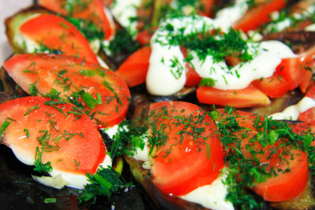 istock Fried eggplants and fresh tomato with souce and herbs 1155365857