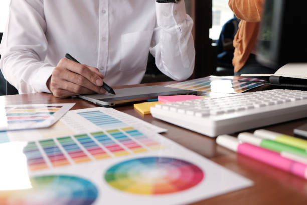 istock Graphic designer working on digital tablet. artist drawing on graphic tablet and Color swatch samples. 1155367129