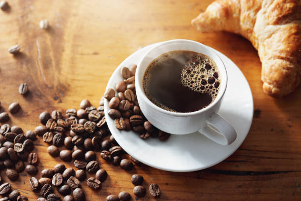 istock Cup of hot coffee on wooden table 1155367397