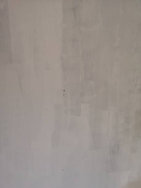 цементная стена краска белого цвета незавершенной грубой текстуры поверхности - unfinish стоковые фото и изображения
