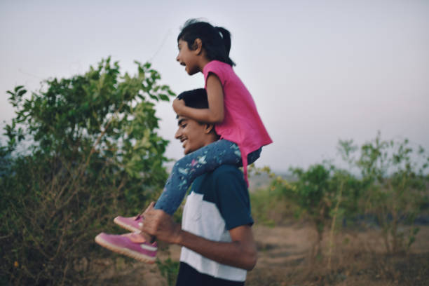 istock Brother takes his young sister piggyback while hiking 1155368587