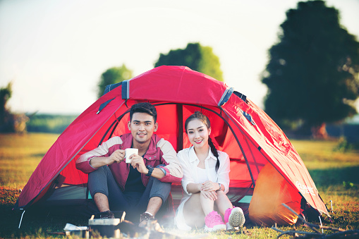 Romantic couple sitting in tent at camping site