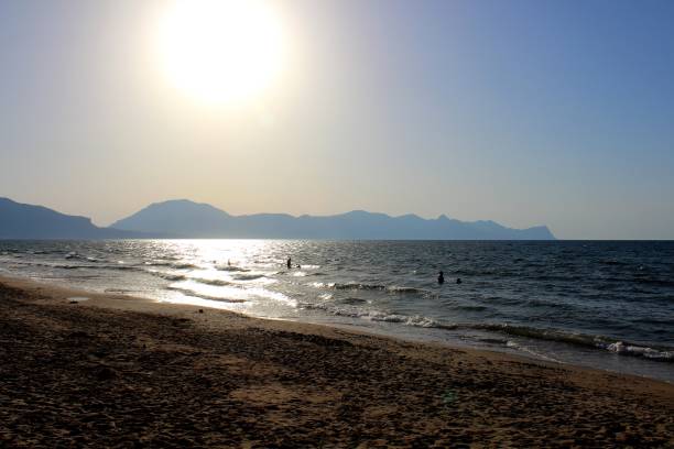 istock beach in Sicily with promontory in the background 1155372191