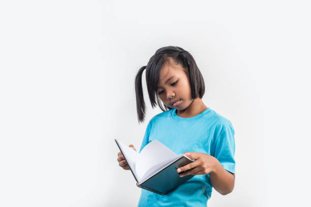 istock little girl reading book in studio shot 1155372201