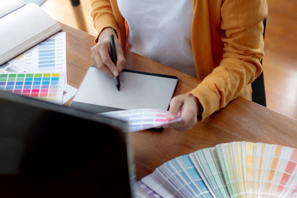 istock Interior or Graphic designer meeting discussing about color chart in studio. 1155372235