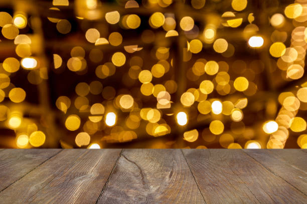istock Christmas Bokeh background with empty wooden table 1155372703