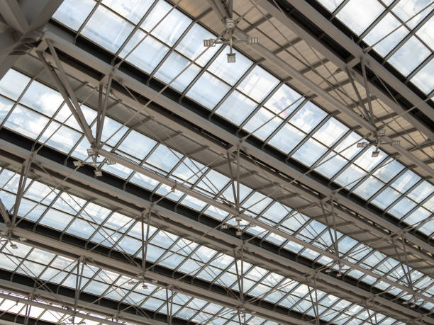 istock Abstract high-tech architecture background photo, Large steel structure truss, roof frame and metal sheet in building construction site in the airport. 1155376356