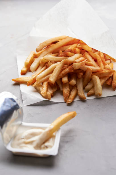 istock french fries in paper and sauces 1155376880