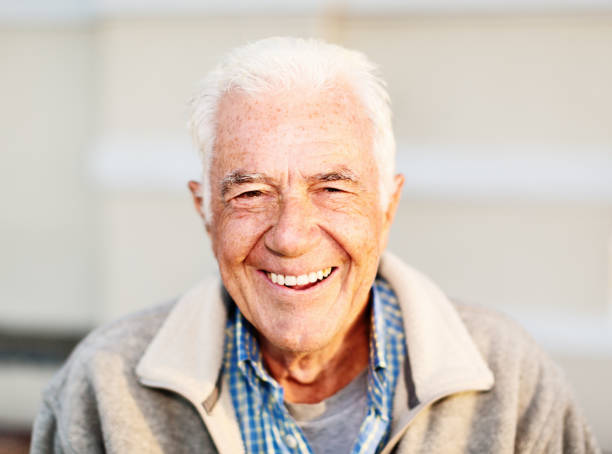 istock Senior man smiles happily, relaxing in bright sunshine 1155377773