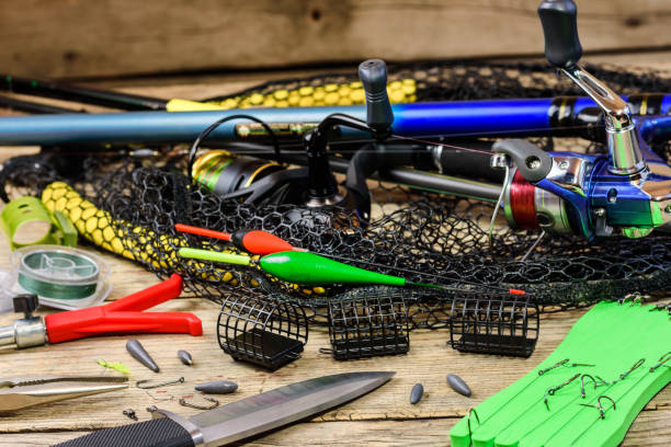 istock Fishing equipment on a wooden table 1155378623