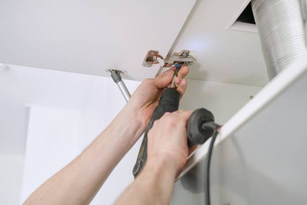 istock Closeup of hand worker doing furniture, assembling kitchen with professional tools 1155379485