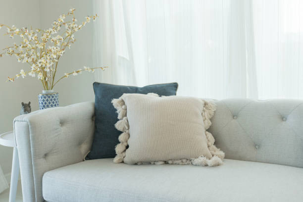 istock white couch with pale blue wall and window. 1155380398