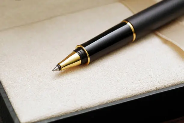 macro of black luxury gold plated ballpoint pen in case