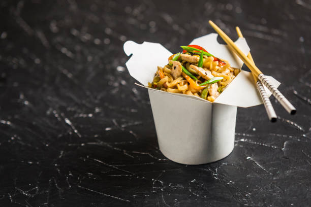 chinese noodles in a box with chicken and vegetables with sticks - teriyaki broccoli carrot chicken imagens e fotografias de stock