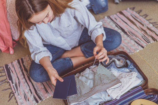istock Happy woman planning a travel preparing a suitcase 1155384987