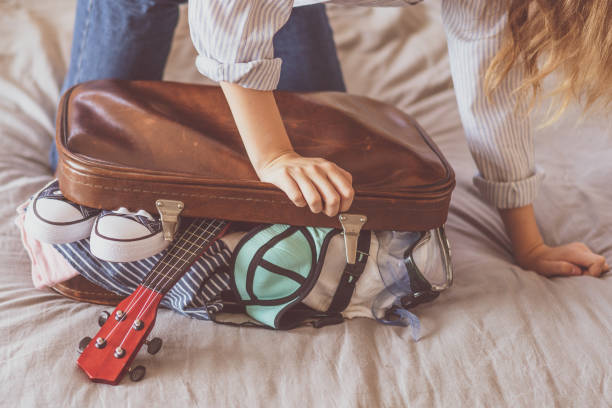 istock Happy woman planning a travel preparing a suitcase 1155385174