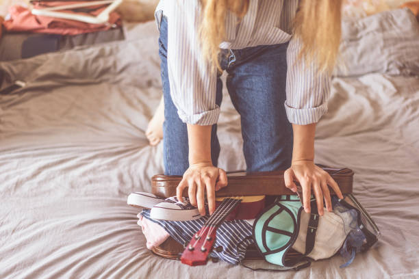 istock Happy woman planning a travel preparing a suitcase 1155385175