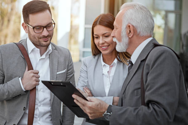 istock Business team discussing documents in front of office 1155385430
