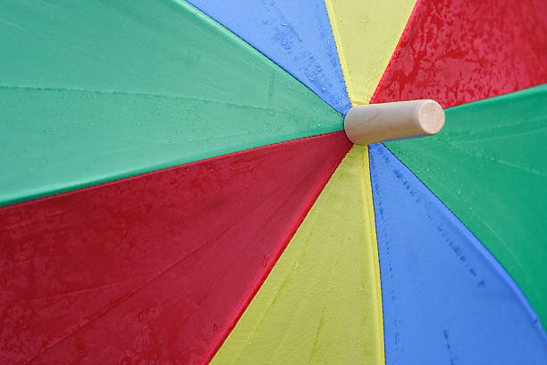 istock Colorful Umbrella soaked with raindrops 115538965